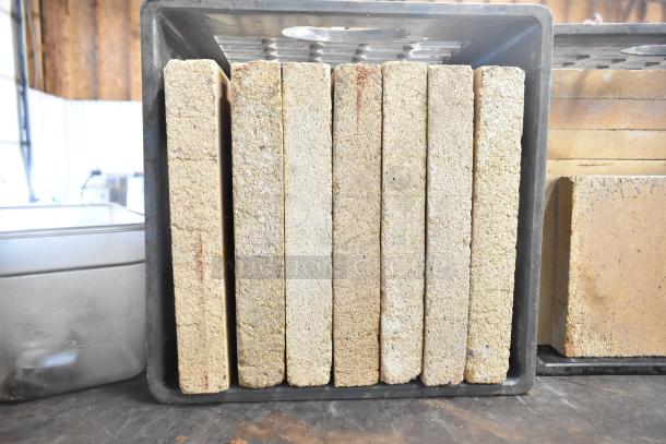 Montague 14-P-1 commercial pizza oven cooking stones stacked. Stones show signs of use, in metal tray.