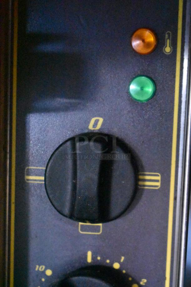 Control panel of Sodir Equipex CT540 conveyor toaster showing a rotary dial and indicator lights.