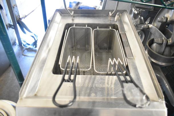 Waring WPC100 electric pasta cooker rethermalizer with dual baskets, stainless steel, marked with "Caution: Hot Surface."