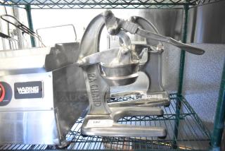RA Chand Countertop Manual Citrus Juicer, durable metal build, used condition, visible brand engraving, item tagged.