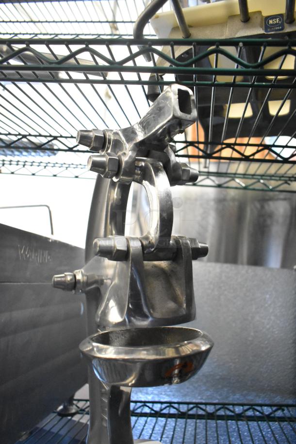 RA Chand manual citrus juicer, stainless steel, countertop model. Features a sturdy lever and bowl, slightly used condition.