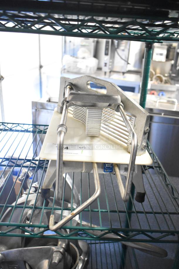 Stainless steel countertop tomato slicer with sturdy base, multiple blades, and NSF certification tag, in used condition.