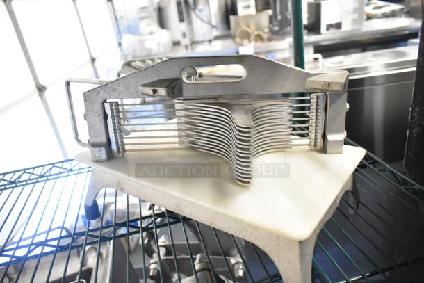 Countertop tomato slicer with stainless steel blades and sturdy frame, in good condition; ideal for efficient kitchen prep.