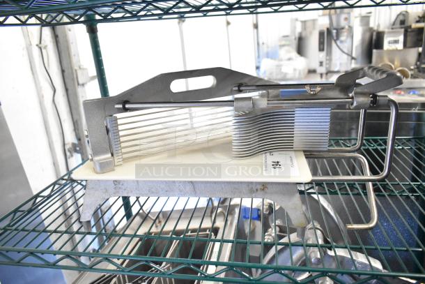 Countertop Tomato Slicer with stainless steel blades, mounted on a sturdy metal base. Appears in good condition. Auction tag "194".