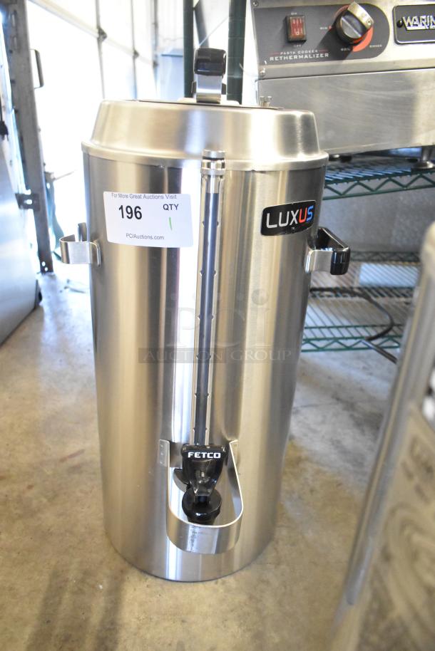 BRAND NEW Fetco TPD-30 Luxus 3 Gallon Stainless Steel Coffee Dispenser, scratch and dent. Visible labels: "196," "LUXUS."