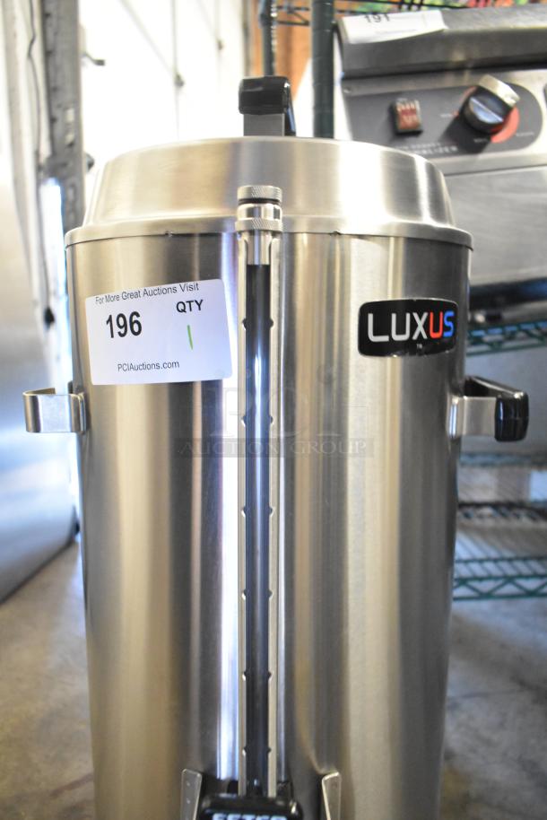 BRAND NEW Fetco TPD-30 Luxus 3-Gallon Stainless Steel Coffee Dispenser, scratch and dent, with auction label.
