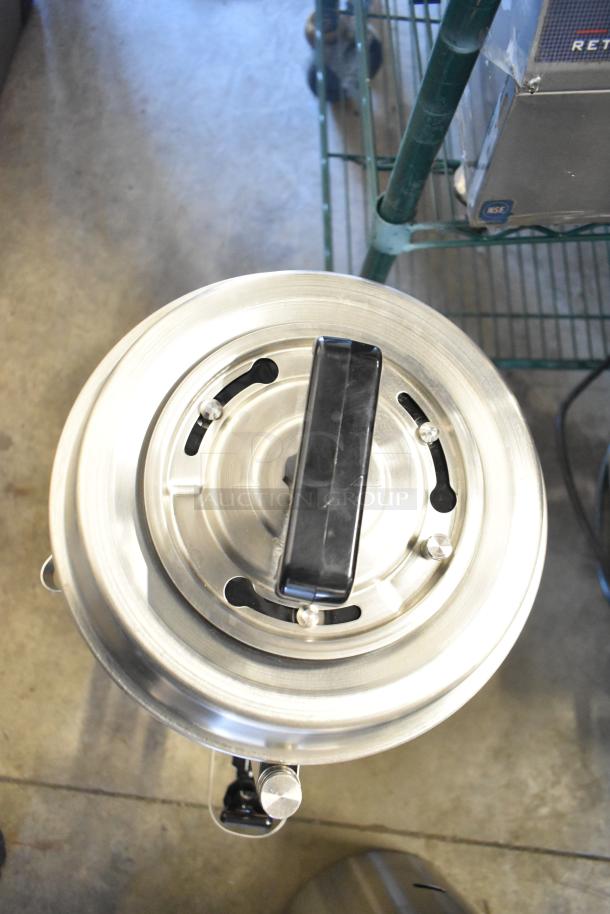 BRAND NEW SCRATCH AND DENT! Fetco TPD-30 Luxus 3 Gallon Stainless Steel Coffee Dispenser, top view, with handle.