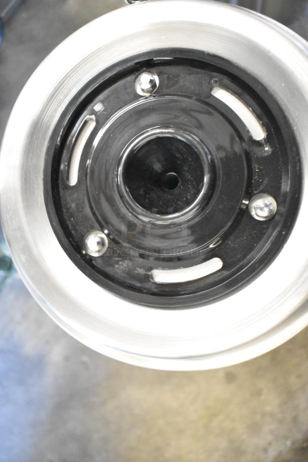 Brand new Fetco TPD-30 Luxus 3-gallon coffee dispenser, stainless steel, scratch and dent condition, top view detail.