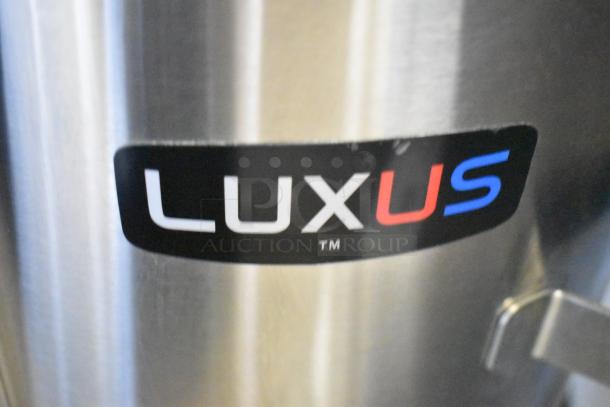 Brand new Fetco TPD-30 Luxus 3-gallon stainless steel coffee dispenser, scratch and dent model, visible Luxus logo.