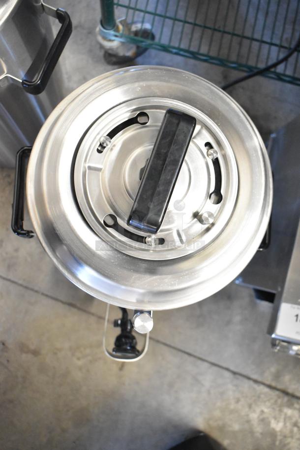 BRAND NEW SCRATCH AND DENT! Fetco TPD-30 stainless steel coffee dispenser, 3-gallon capacity, top view, minor dents visible.