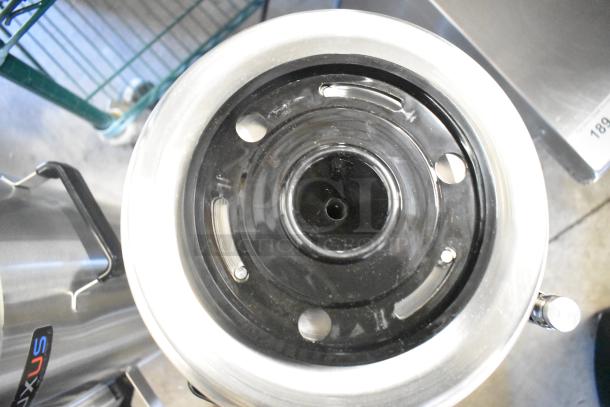 Stainless steel Fetco TPD-30 Luxus 3-gallon coffee dispenser, brand new condition with minor scratches, visible logo.