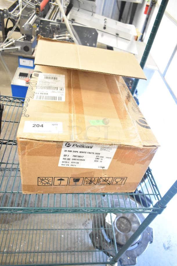 Cardboard box of Pelliconi casters, labeled "38 MM SNPL WHITE FACTS 2020," showing quantity and product codes, on a metal shelf.