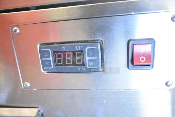 ServIt 423HDM26SA countertop heated display case control panel, with temperature settings and power switch visible.