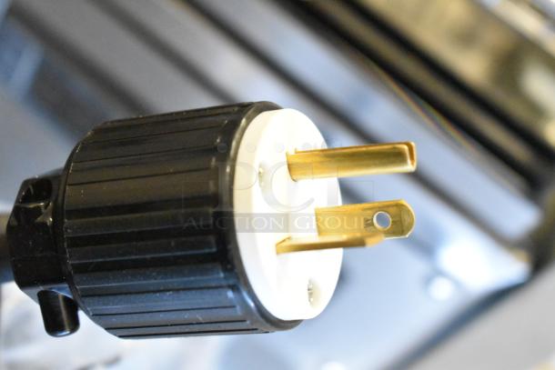 Close-up of the plug for the ServIt 423HDM26SA 26" heated display case, showing a grounded three-prong connector.