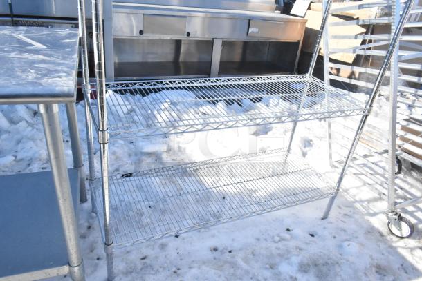 Chrome finish 4-tier wire shelving unit in good condition. Buyer must dismantle. Consider freight charges for shipping.