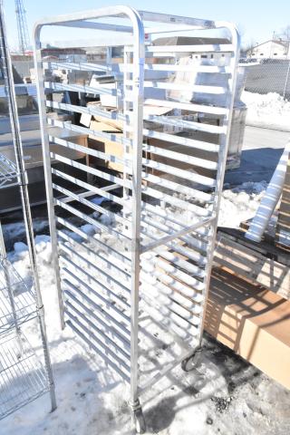 Commercial pan transport rack on sturdy casters, metal frame, multiple shelves for pan storage, excellent condition.