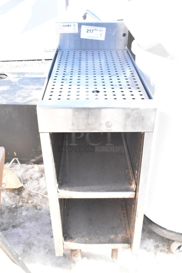 Commercial drain board with two under shelves, stainless steel, used condition, label showing model and auction details visible.