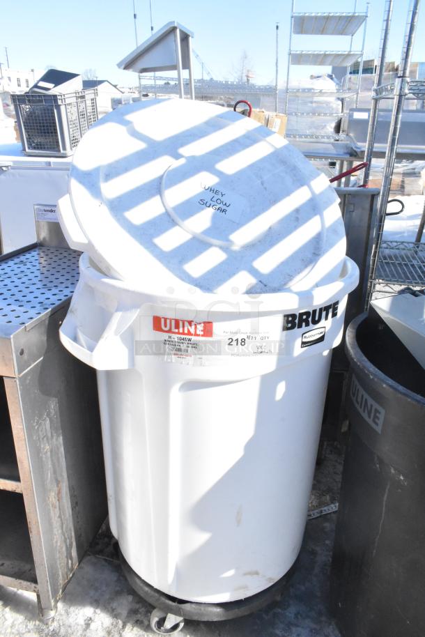 Poly trash cans with contents, brands Uline and Rubbermaid Brute, labeled "Whey Low Sugar," on wheels.