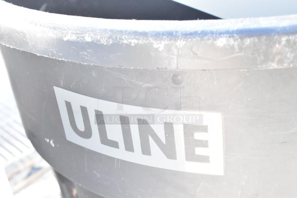 Two Uline poly trash cans, shown with some wear. Each contains contents. Auction includes double your bid.