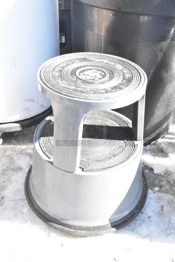 Two poly trash cans with contents, featuring a textured surface and durable design. Includes a black and a white can.