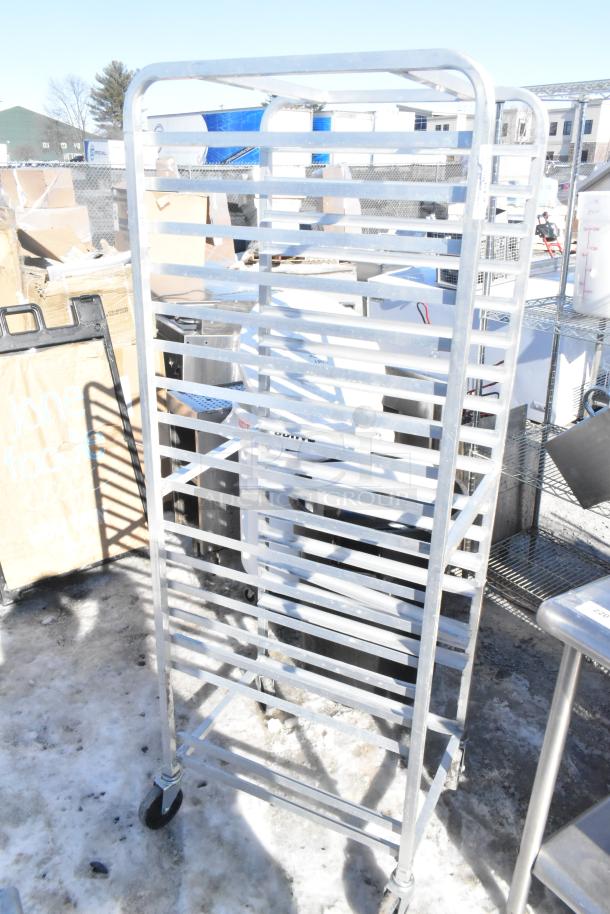Commercial pan transport rack with metal shelving and sturdy commercial casters. Good condition for catering use.