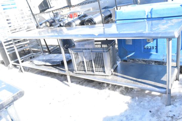 Stainless steel commercial table with spacious under shelf, sturdy design, used condition, ideal for kitchen or industrial use.