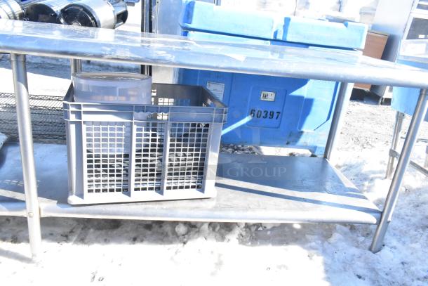 Commercial stainless steel table with under shelf, used condition, featuring a sturdy design.