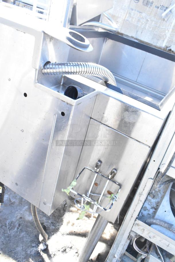 Commercial ice bin with Wunderbar soda gun, stainless steel, features drainage hose, used condition with visible wear.