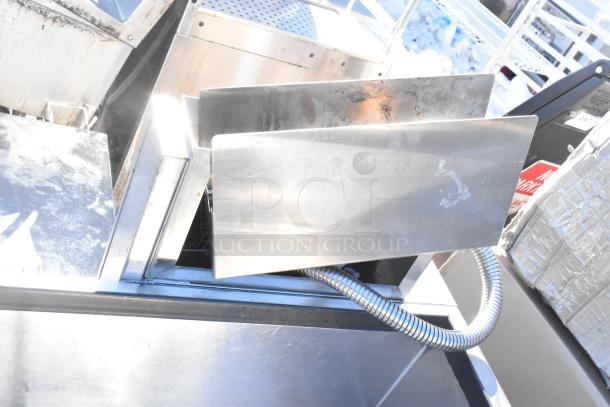 Commercial ice bin with attached Wunderbar soda gun, stainless steel construction, some visible wear, flexible hose connected.