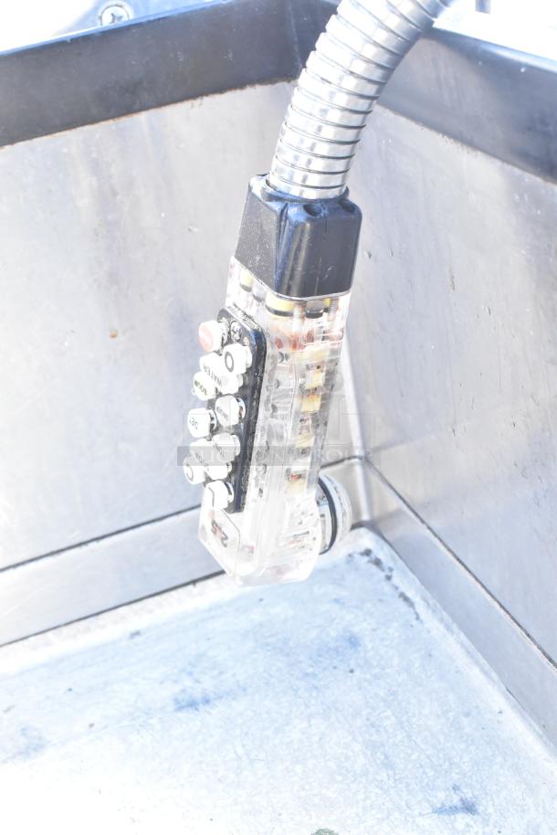 Commercial ice bin with Wunderbar soda gun attached, showing multiple buttons for beverage selection. Stainless steel interior.