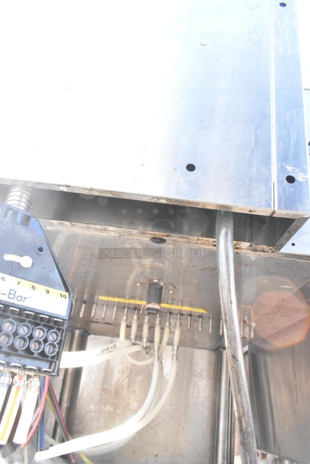 "Commercial ice bin with Wunderbar soda gun attached, showing wiring and tubes. Steel construction, used condition."