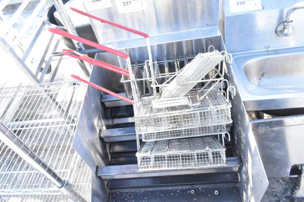 Glastender LDA-18S liquor display with four levels, featuring attached fry baskets with red handles, used condition.