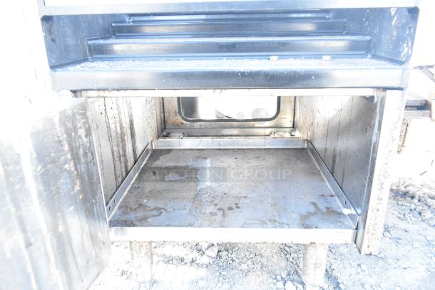 Glastender LDA-18S 4 Level Raised Liquor Display in used condition with visible wear, includes fry baskets, stainless steel construction.