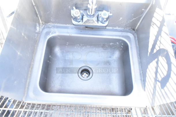 Chrome finish 4-tier wire shelving unit with sink, visible wear. Buyer must dismantle. Consider freight charges.