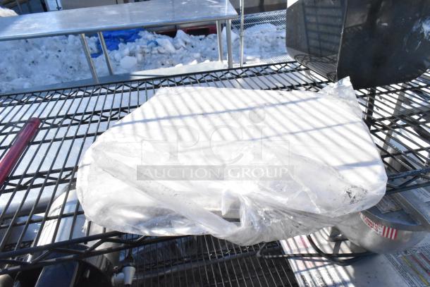 Black finish 4-tier wire shelving unit with napkin dispensers, undismantled. Buyer responsible for dismantling and freight.