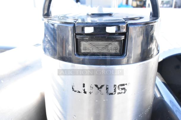 Stainless steel container with "LUXUS" logo and black plastic top, featuring an LCD display panel.
