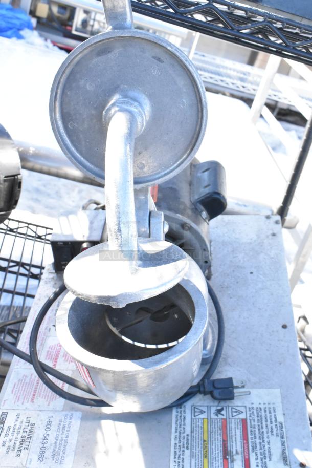 Black 4-tier wire shelving with napkin dispensers, shown with metal components and labels indicating usage warnings.