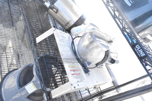 Black finish 4-tier wire shelving unit with Uline napkin dispensers. Requires dismantling for shipping. Includes warning labels.