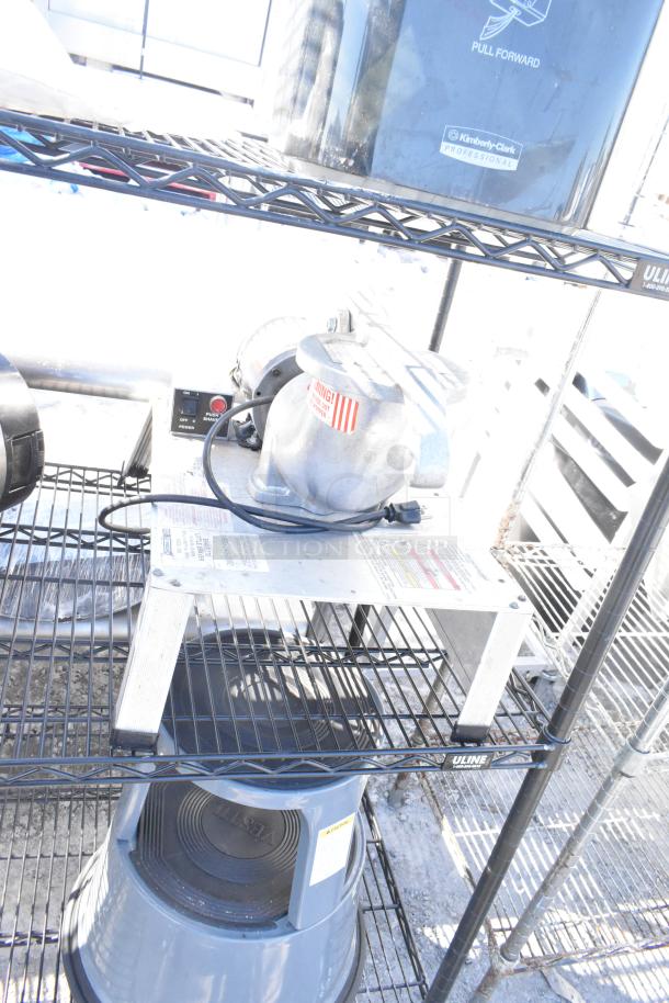 Black 4-tier wire shelving unit with napkin dispensers, requiring buyer dismantling. Visible label from Uline. Consider freight.
