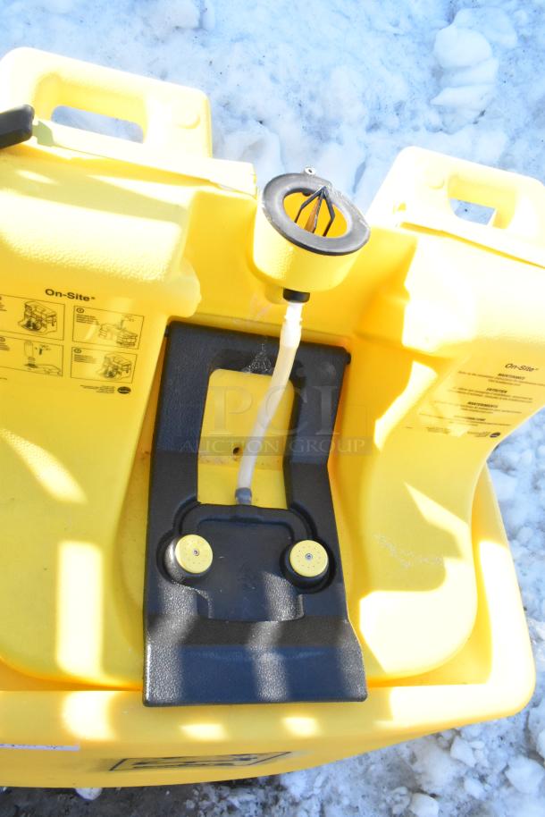 Bradley S19-921 gravity feed eye wash, yellow, with instructional labels, in good condition, outdoor setting.