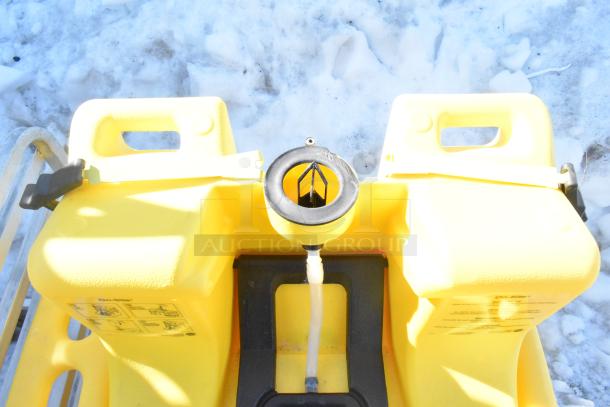 Bradley S19-921 Gravity Feed Eye Wash, yellow unit, outdoor setting, visible usage instructions on side.