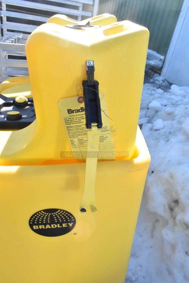 Bradley S19-921 Gravity Feed Eye Wash, yellow, new condition, with inspection tag and visible Bradley logo.