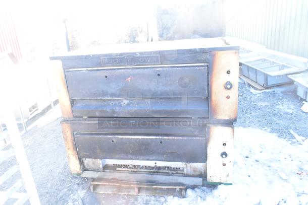 2 Montague 24P-2 commercial pizza ovens, natural gas, single deck, visibly worn condition, includes control knobs and vents.