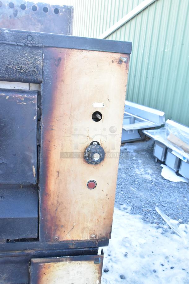 Montague 24P-2 commercial natural gas single deck pizza oven with visible wear and temperature control knob.