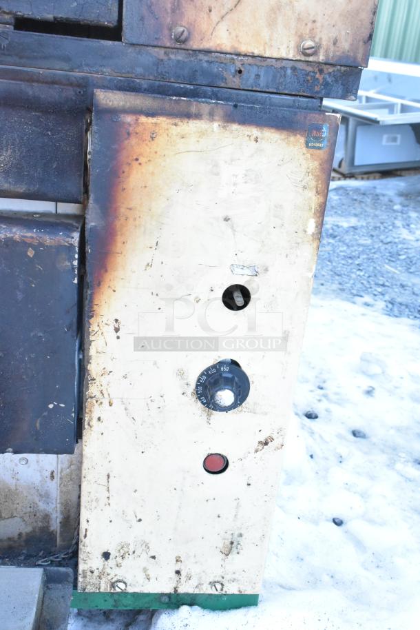 Two Montague 24P-2 commercial natural gas single deck pizza ovens, showing control dials and weathered exterior condition.