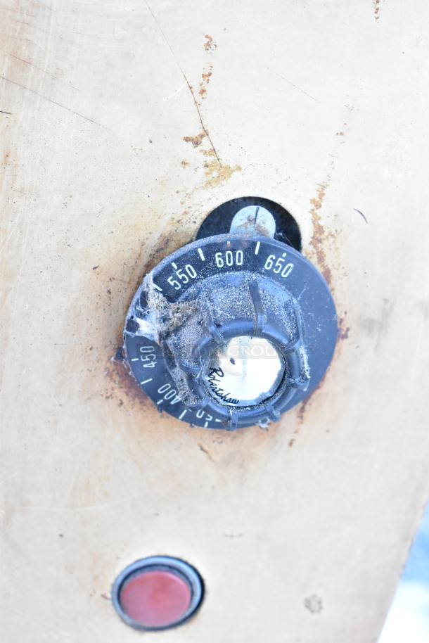 Montague 24P-2 pizza oven temperature dial. Shows range from 400-650°F. Signs of wear and rust on panel.
