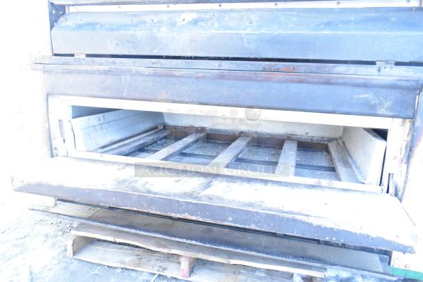 Two Montague 24P-2 commercial natural gas single-deck pizza ovens, showing signs of use, open interior view.