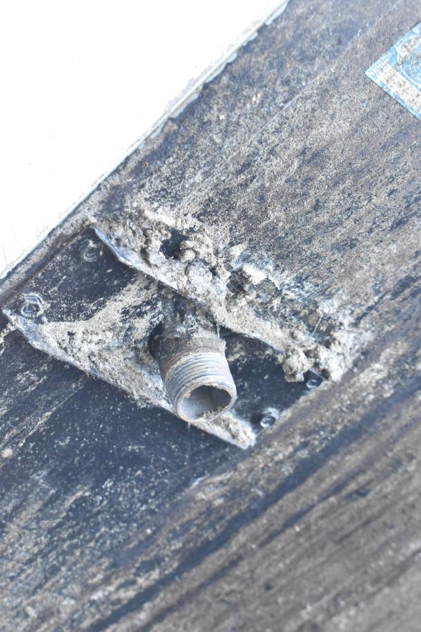 Close-up of a gas connector on a Montague 24P-2 Commercial Pizza Oven with visible wear.
