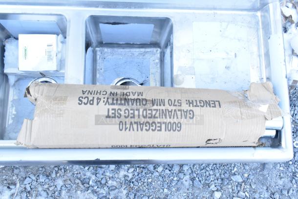 Brand new Regency 600S31014212 16-gauge stainless steel sink, 3 compartments, galvanized legs, two drainboards. Box shows contents.