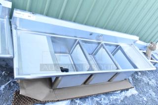 Brand new Regency 600S31824218, 16-gauge stainless steel three-compartment sink with two drainboards, no legs, minor dents.